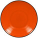 An orange RAK Porcelain deep coupe plate with a black rim.