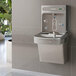 An Elkay light gray wall-mounted water fountain with a bottle filling station.