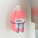 A Dema 1 station metal rack holding a pink round gallon bottle of liquid.