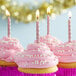 Pink cupcakes with metallic rose gold spiral candles.