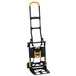 A black and yellow Cosco 2-in-1 folding hand truck.