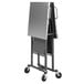 A Cosco stainless steel folding work table on a metal cart.