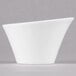 A white Arcoroc Ludico deep bowl on a gray surface.