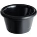 An Acopa black smooth melamine ramekin on a table with a white background.