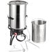 A stainless steel Backyard Pro seafood boiler and steamer pot with a pot holder.