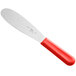 A Choice stainless steel sandwich spreader with a red handle.