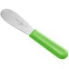 A stainless steel sandwich spreader with a neon green handle.