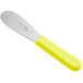 A stainless steel sandwich spreader with a neon yellow handle.