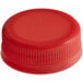 A close-up of a red plastic bottle cap with a lid on top.