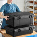 A black top-loading insulated food pan carrier designed to hold a full-size food pan with lid.