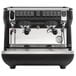 A black and silver Nuova Simonelli Appia Life Compact 2 Group Volumetric Espresso Machine on a counter.