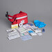 A red Medique fanny pack first aid kit with various items on the side.