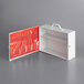 A white metal box with a red pocket organizer inside.