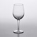A clear Pasabahce wine glass on a white surface.