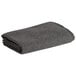A folded charcoal grey Medique fire and rescue blanket.