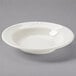 A Tuxton eggshell white china pasta bowl with an embossed rim.