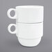 A stack of 12 white Monaco porcelain mugs with handles.