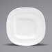 A close up of the front of a white square porcelain plate with a wide rim.