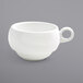A white teacup with a handle.