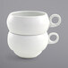 A stack of two Front of the House Monaco bright white stackable porcelain cups with handles.