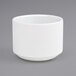 A white Front of the House Monaco porcelain ramekin on a gray surface.