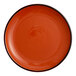 An orange porcelain coupe plate with a smooth, glossy finish.