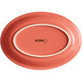 An Acopa Capri coral oval stoneware platter with a white border.