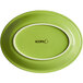 An Acopa Capri green bamboo oval coupe platter with a white rim.