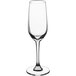 An Acopa Radiance flute glass filled with a clear beverage on a white background.