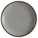 An Acopa Keystone granite gray stoneware coupe plate with speckles.