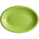 An Acopa Capri green oval stoneware platter with a white border.