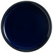 An Acopa Keystone Azora Blue stoneware coupe plate with a black rim and white spots.