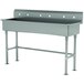 A large stainless steel Advance Tabco utility sink with a metal frame for three faucets.