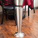 A silver metal American Metalcraft bucket stand on a table.