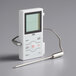 A white CDN digital cooking thermometer with a metal probe and a screen.