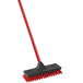 A red and black Libman floor scrub with a handle.