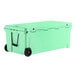 A seafoam green CaterGator outdoor cooler with black wheels.