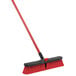 A red and black Libman Multi-Surface Push Broom with a handle.