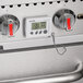 A white Taylor digital cooking thermometer with buttons and a display.