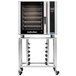 A Moffat commercial convection oven on a stand with shelves.