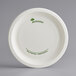 A white Pactiv EarthChoice compostable paper plate with green text.