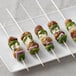 A plate with skewers of meatballs and vegetables on EcoChoice Compostable Wooden Skewers.