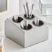 A Choice stainless steel flatware organizer with black perforated plastic containers holding silverware.