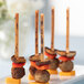 A group of meatballs and cheese skewers on TreeVive by EcoChoice willow flat food picks on a table.