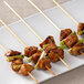 A plate with meat and vegetables on EcoChoice bamboo skewers.
