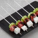 A plate of watermelon, cucumber, and feta cheese on EcoChoice wooden skewers.