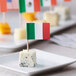 A plate of cheese sticks with Italian flag picks.