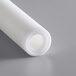 A roll of white plastic with a small hole in the center.
