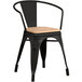 A Lancaster Table & Seating black metal arm chair with a natural wood seat.