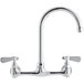 A chrome Regency wall mount faucet with two silver handles and a swivel gooseneck spout.